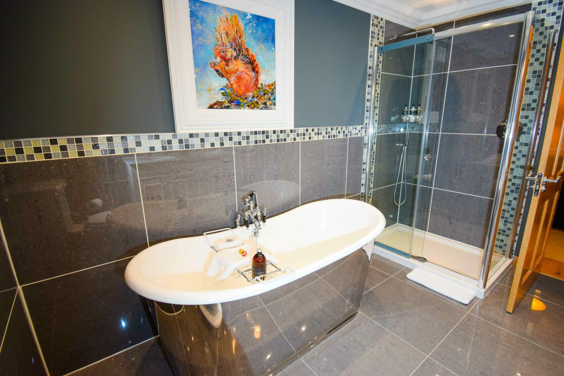 The free-standing bath and rainfall shower enclosure in our Outlander Luxury Hideaway, Glencoe