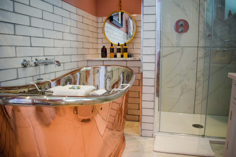 The bathroom at Little Fox Lodge is stunning with its free-standing copper and chrome bathtub and designer finishings